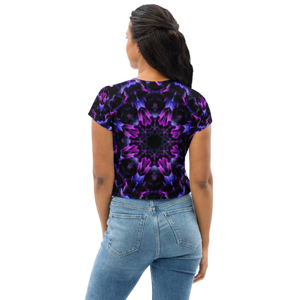 Product Photograph of a unisex Bleace MetaParty Vibes Kaleidoscopic purple, blue, and pink, Trippy Visual crop top tee shirt in the foreground with a white background.