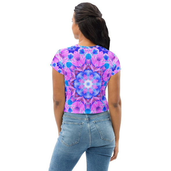 Photograph of a model wearing a unisex Bleace MetaParty Vibes Kaleidoscopic pink, light blue, Trippy Visual crop top shirt. 