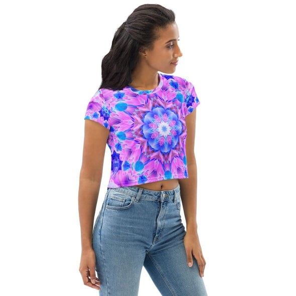 Photograph of a model wearing a unisex Bleace MetaParty Vibes Kaleidoscopic pink, light blue, Trippy Visual crop top shirt.  