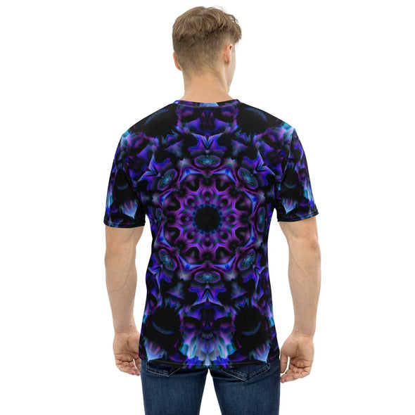 Photograph of a model wearing a unisex Bleace MetaParty Vibes Kaleidoscopic purple, blue, and pink, Trippy Visual tee shirt in the foreground with a white background.  