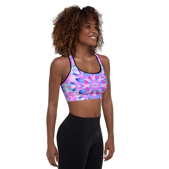 Photograph of a model wearing a Bleace MetaParty Vibes Kaleidoscopic pink, light blue, Trippy Visual sports bra.  