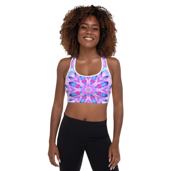 Photograph of a model wearing a Bleace MetaParty Vibes Kaleidoscopic pink, light blue, Trippy Visual sports bra.  
