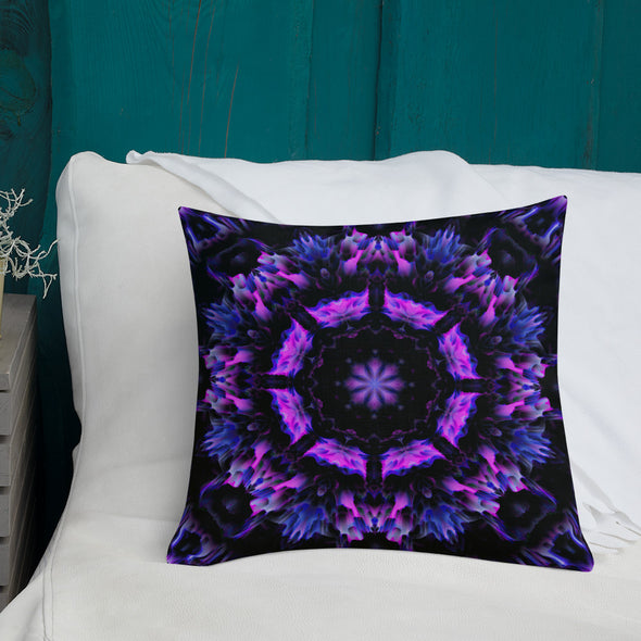 Photograph of a model wearing Bleace unisex MetaParty Vibes Kaleidoscopic purple, blue, and pink, Trippy Visual pillow placed on a chair in the foreground with a white couch in the background.  