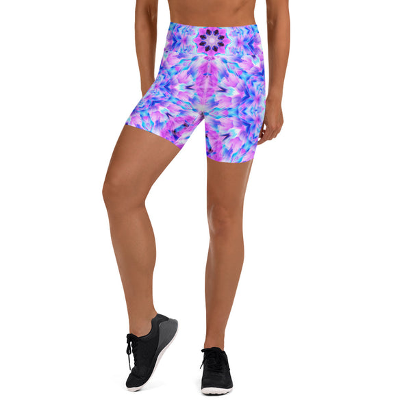 Photograph of a model wearing Bleace unisex MetaParty Vibes Kaleidoscopic pink, light blue, Trippy Visual yoga shorts.  